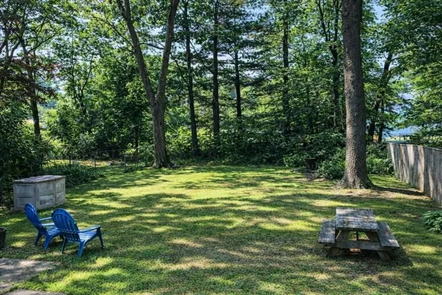 a view of a white house with a yard covered in snow
