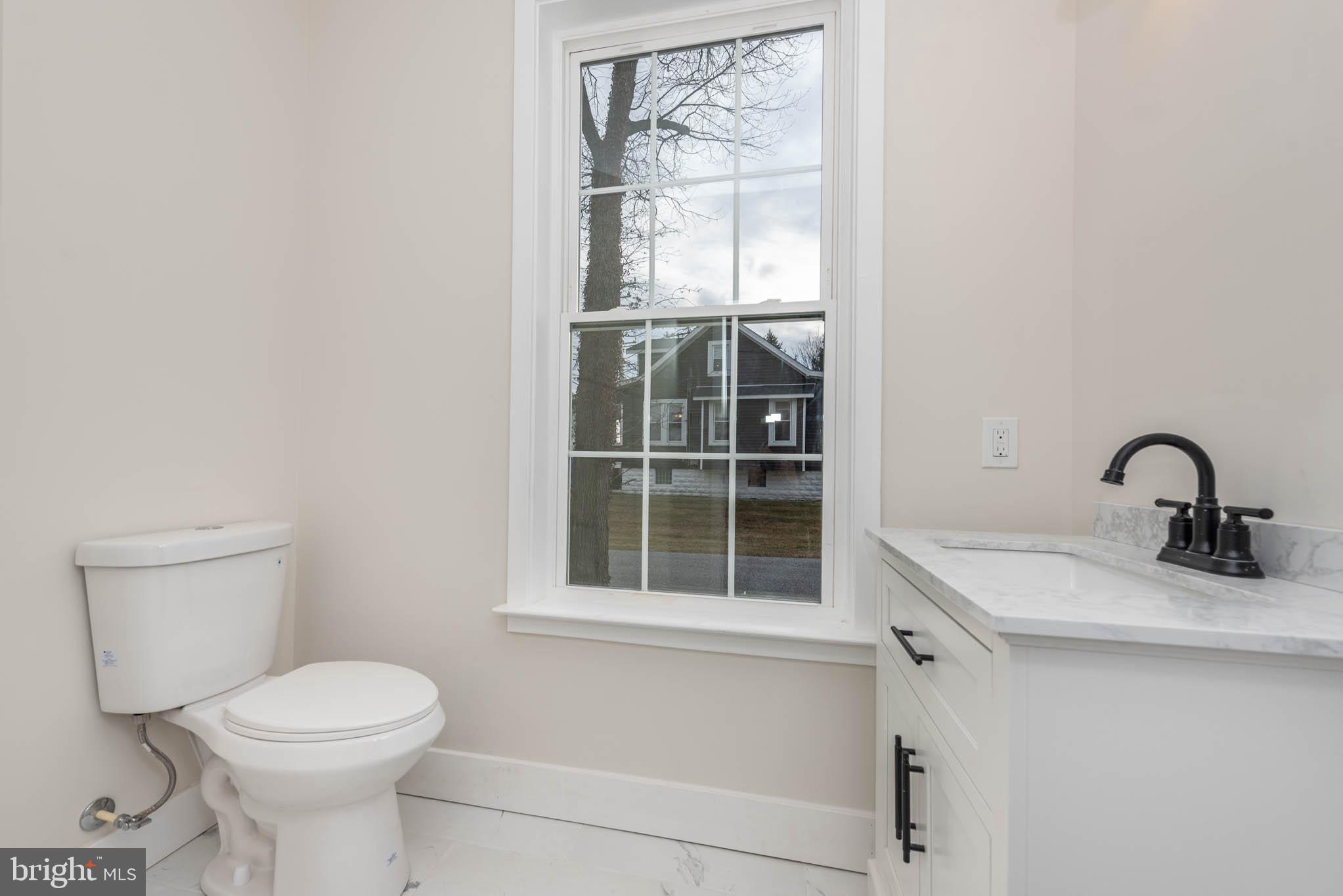 9624 Harford Road Parkville, MD 21234 - Photo 14 of 39 a bathroom with a toilet sink and window