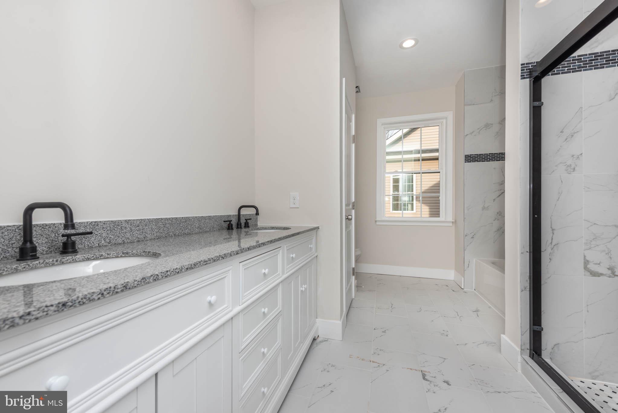 9624 Harford Road Parkville, MD 21234 - Photo 17 of 39 a bathroom with a granite countertop sink and a vanity