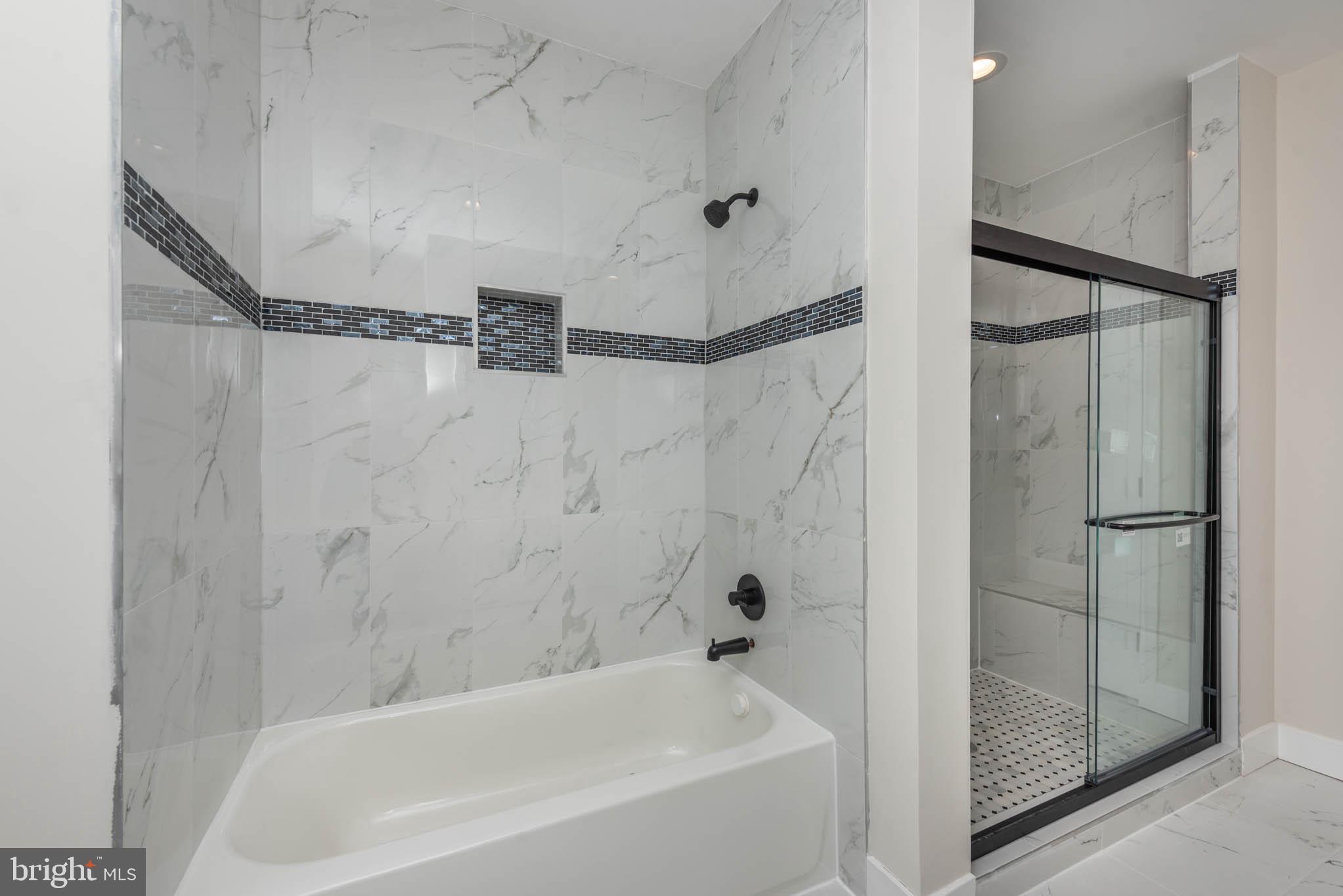 9624 Harford Road Parkville, MD 21234 - Photo 18 of 39 a bathroom with a bathtub and a shower