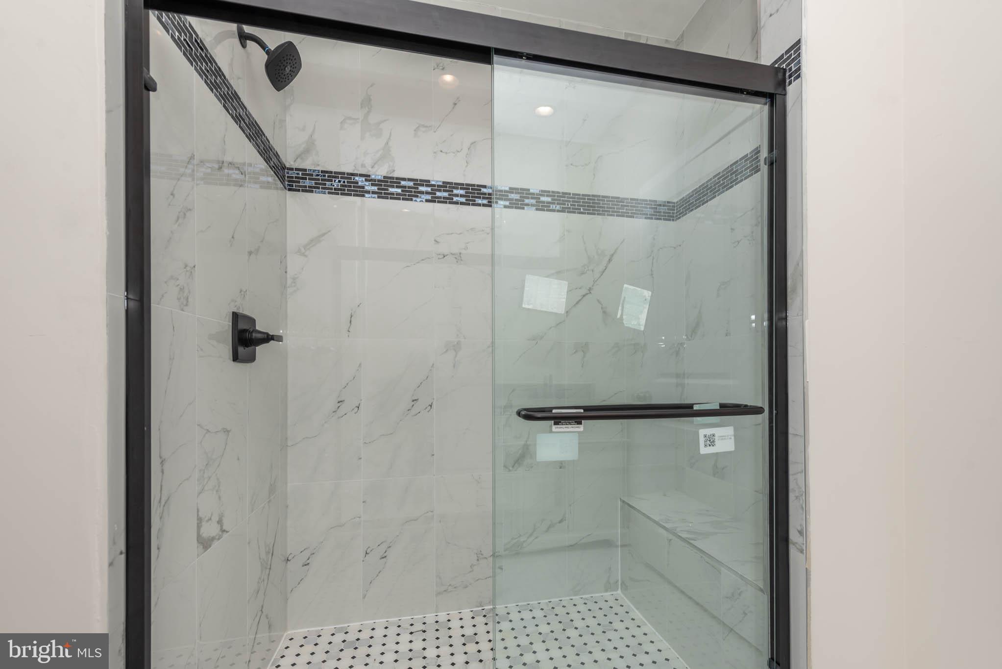 9624 Harford Road Parkville, MD 21234 - Photo 19 of 39 a bathroom with a glass shower door