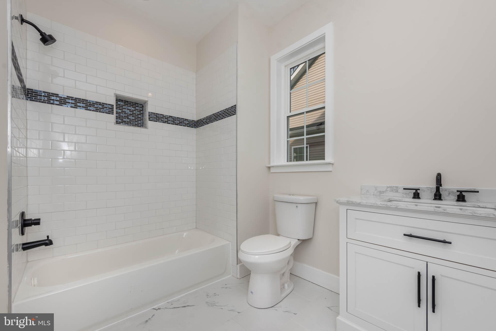9624 Harford Road Parkville, MD 21234 - Photo 22 of 39 a bathroom with a granite countertop sink toilet and shower