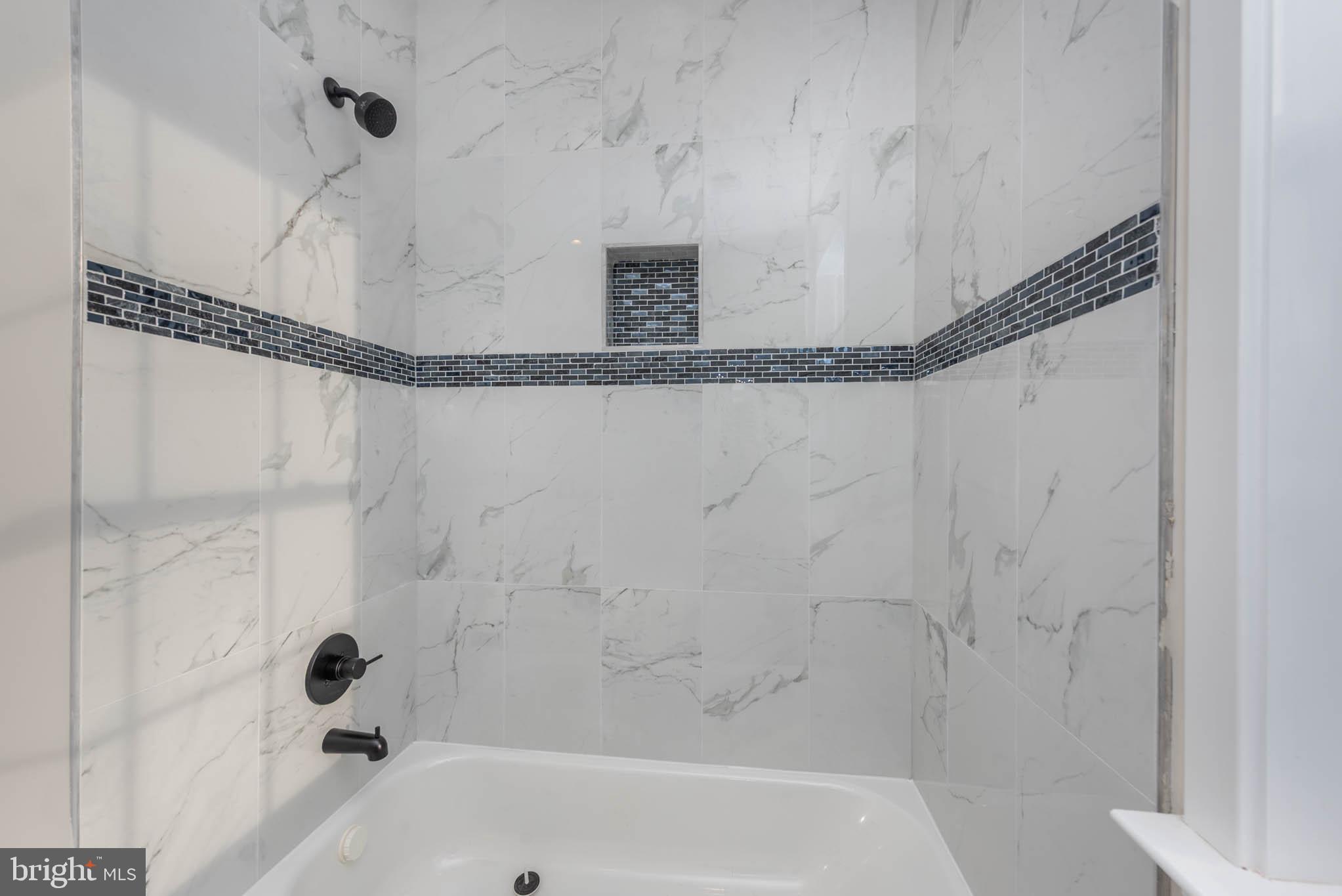 9624 Harford Road Parkville, MD 21234 - Photo 26 of 39 a bathroom with a bathtub and a shower