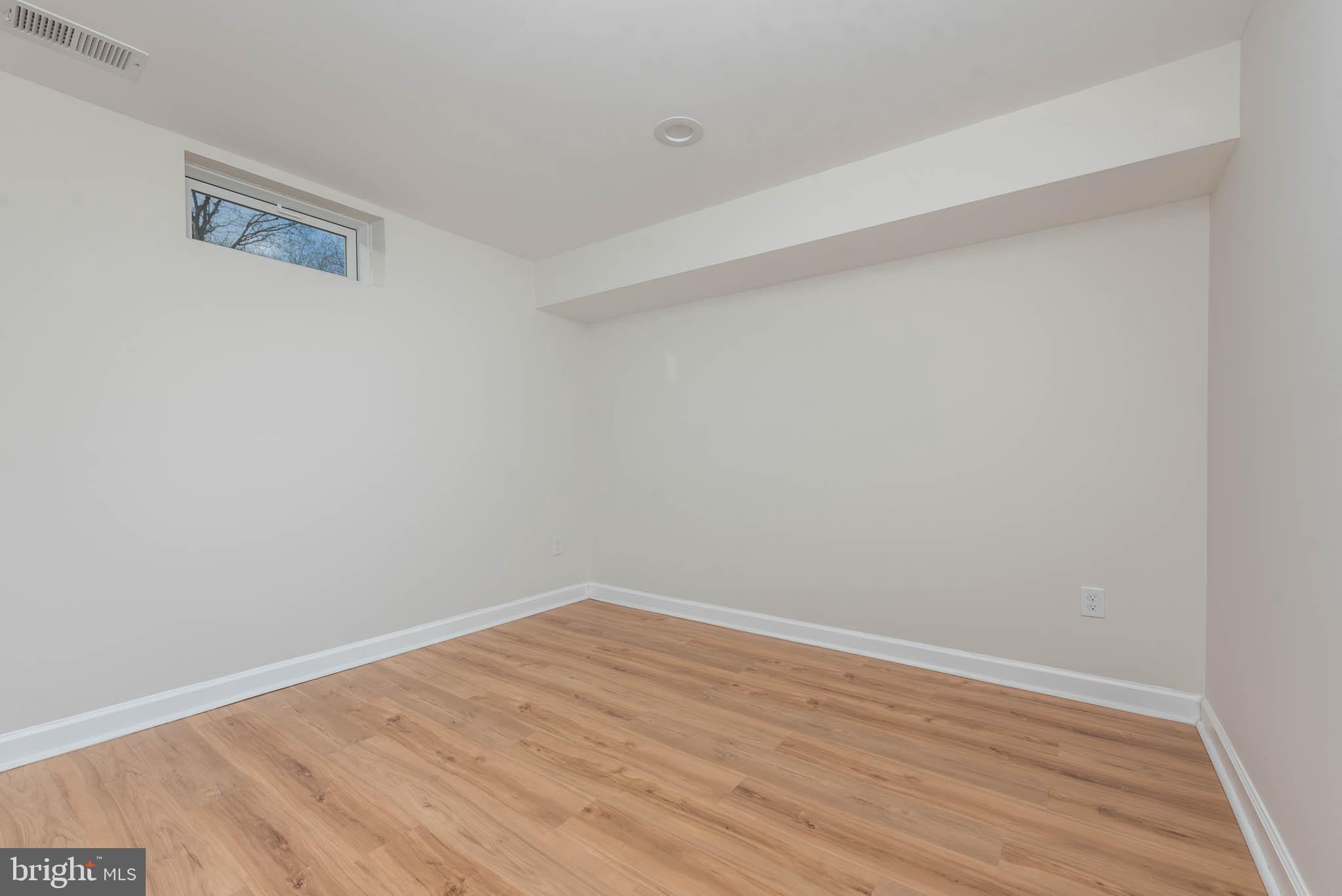 9624 Harford Road Parkville, MD 21234 - Photo 32 of 39 a view of an empty room with wooden floor