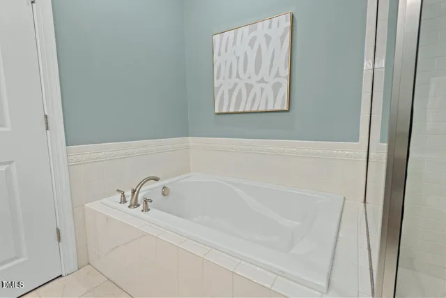 a white bath tub and a sink