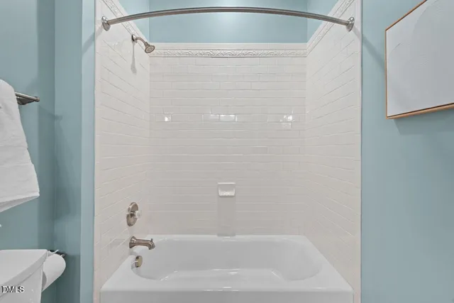 a bathroom with a shower and toilet