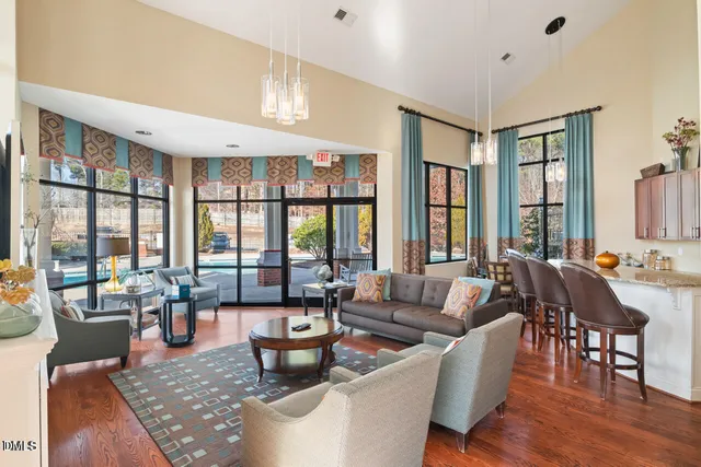 a living room with furniture a lamp and a potted plant