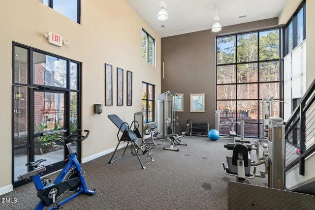 a room with gym equipment and windows