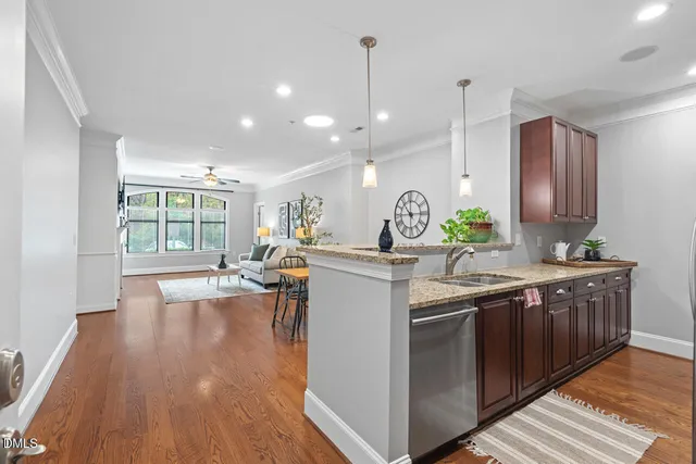 a kitchen with sink stove and wooden floor