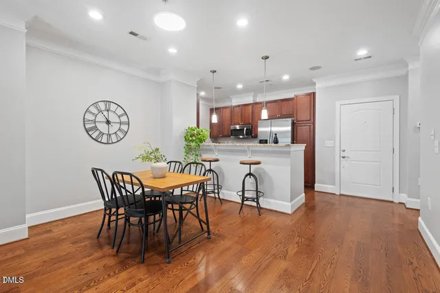 a view of a dining room with furniture and wooden floor