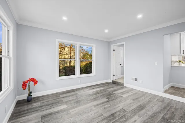 wooden floor in an empty room with a window