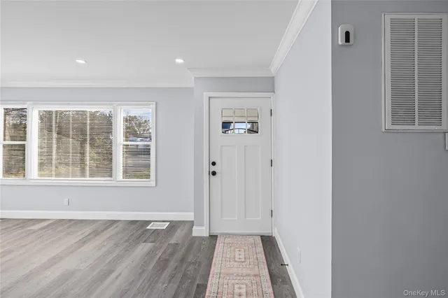 a kitchen with kitchen island a counter top space a sink stainless steel appliances and cabinets