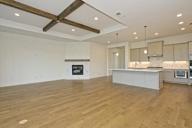 a large kitchen with kitchen island a sink stainless steel appliances and cabinets