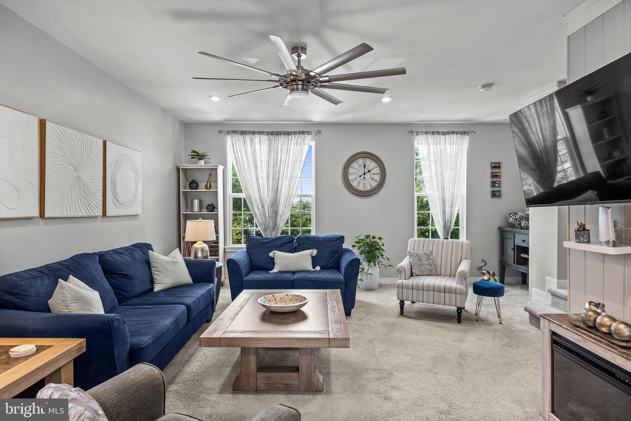 177 Nathan Drive Cinnaminson, NJ 08077 - Photo 13 of 42 a living room with furniture a clock tv and a window