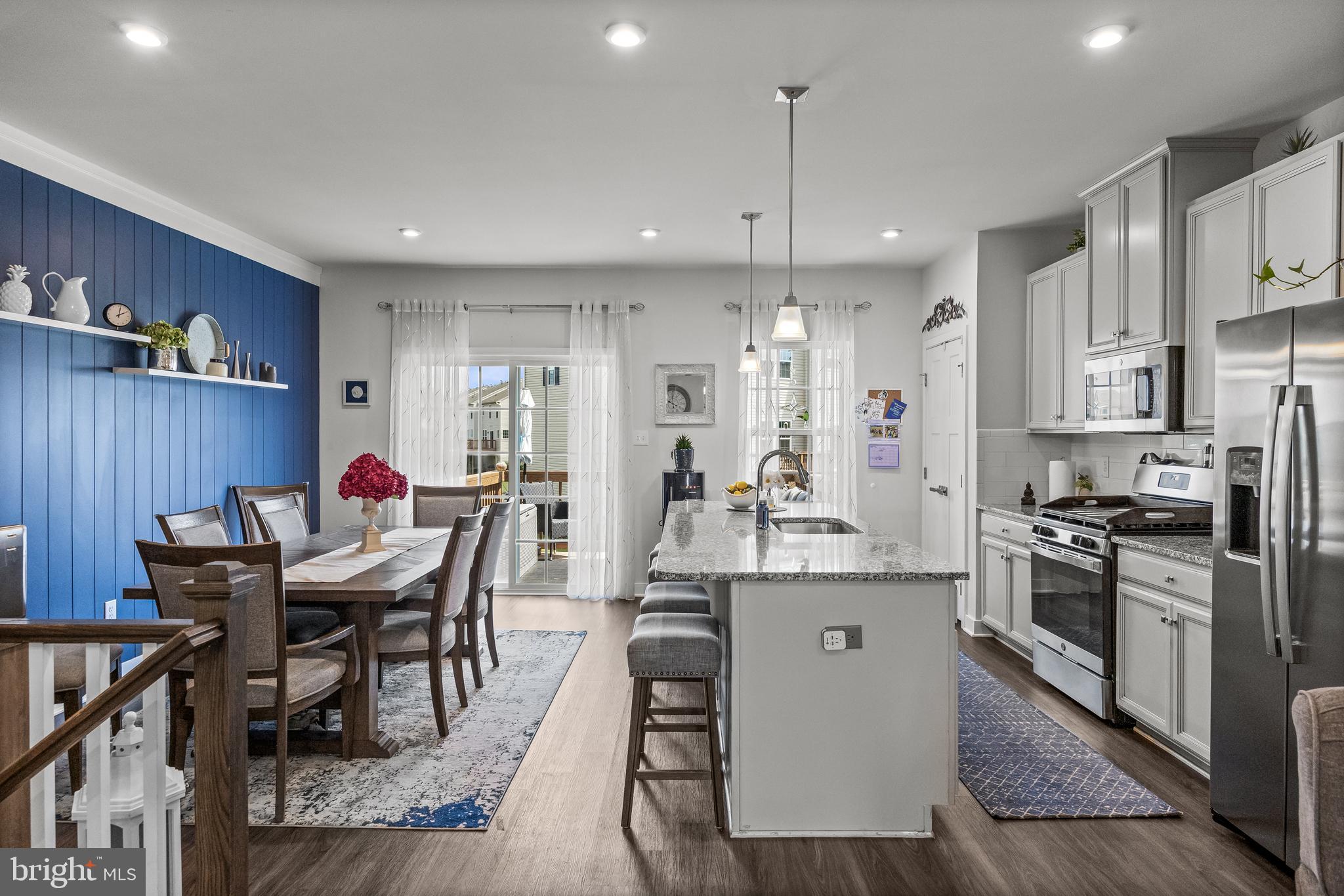 177 Nathan Drive Cinnaminson, NJ 08077 - Photo 17 of 42 a kitchen with stainless steel appliances granite countertop a stove a refrigerator a kitchen island a dining table and chairs