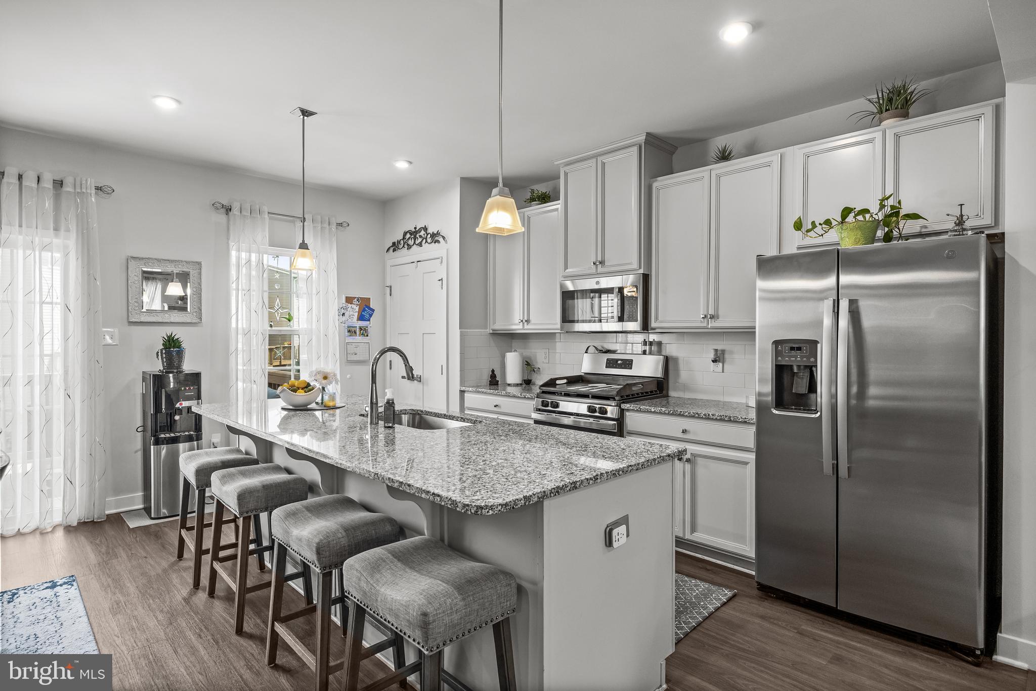 177 Nathan Drive Cinnaminson, NJ 08077 - Photo 19 of 42 a kitchen with refrigerator a sink and chairs