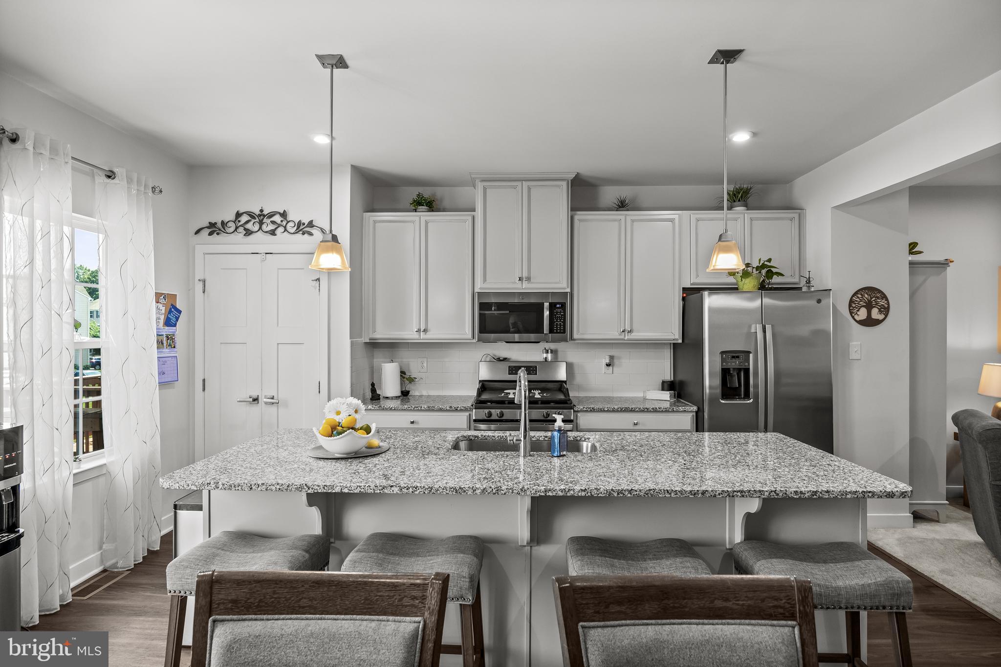 177 Nathan Drive Cinnaminson, NJ 08077 - Photo 20 of 42 a kitchen with refrigerator and chairs
