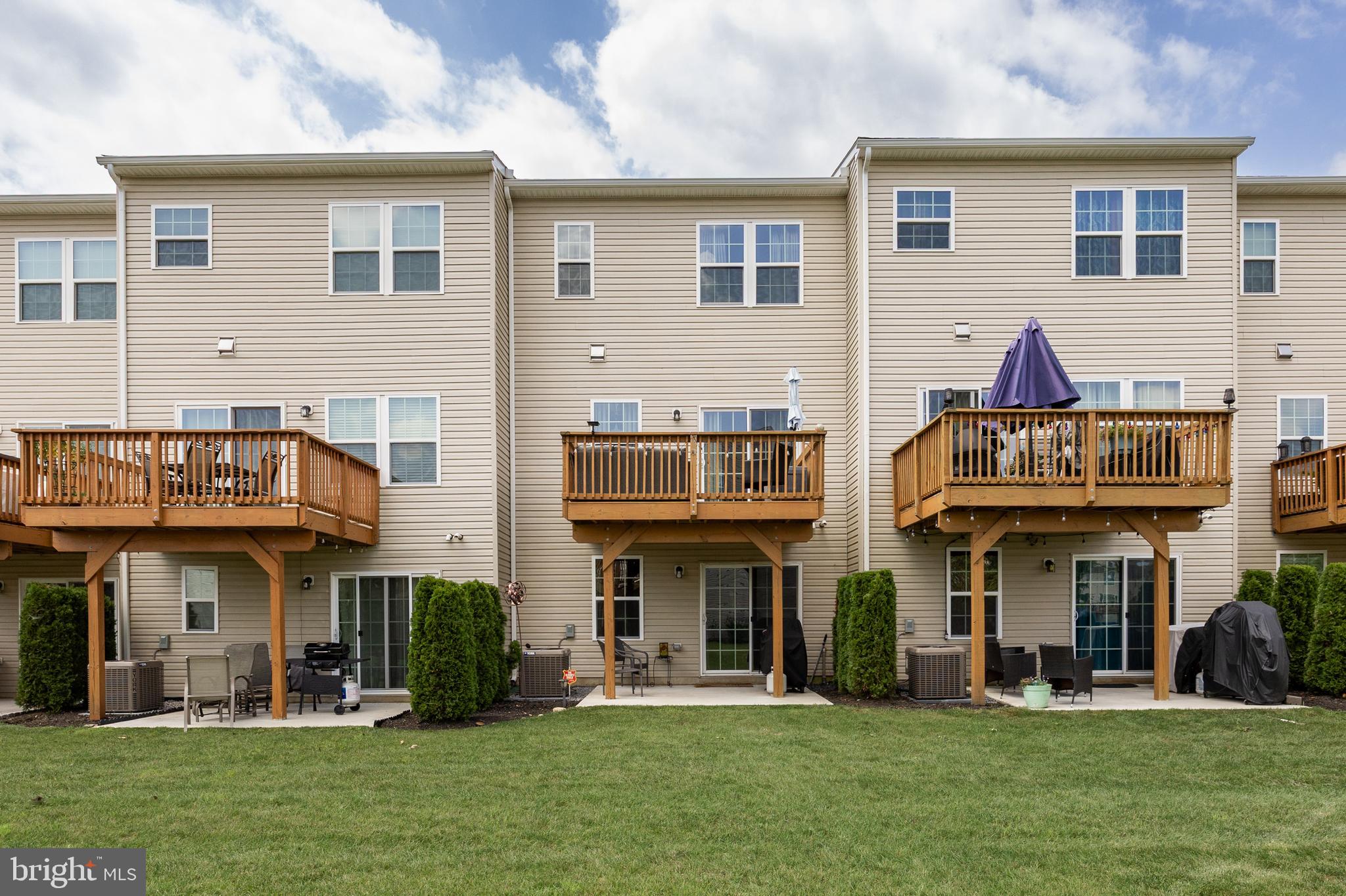 177 Nathan Drive Cinnaminson, NJ 08077 - Photo 31 of 42 a view of a brick building with many windows and a yard