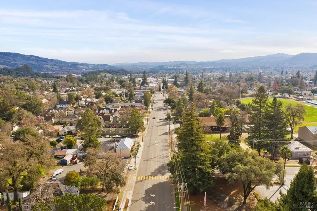 an aerial view of residential building and trees around