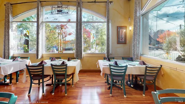 a dining room with furniture wooden floor and a chandelier