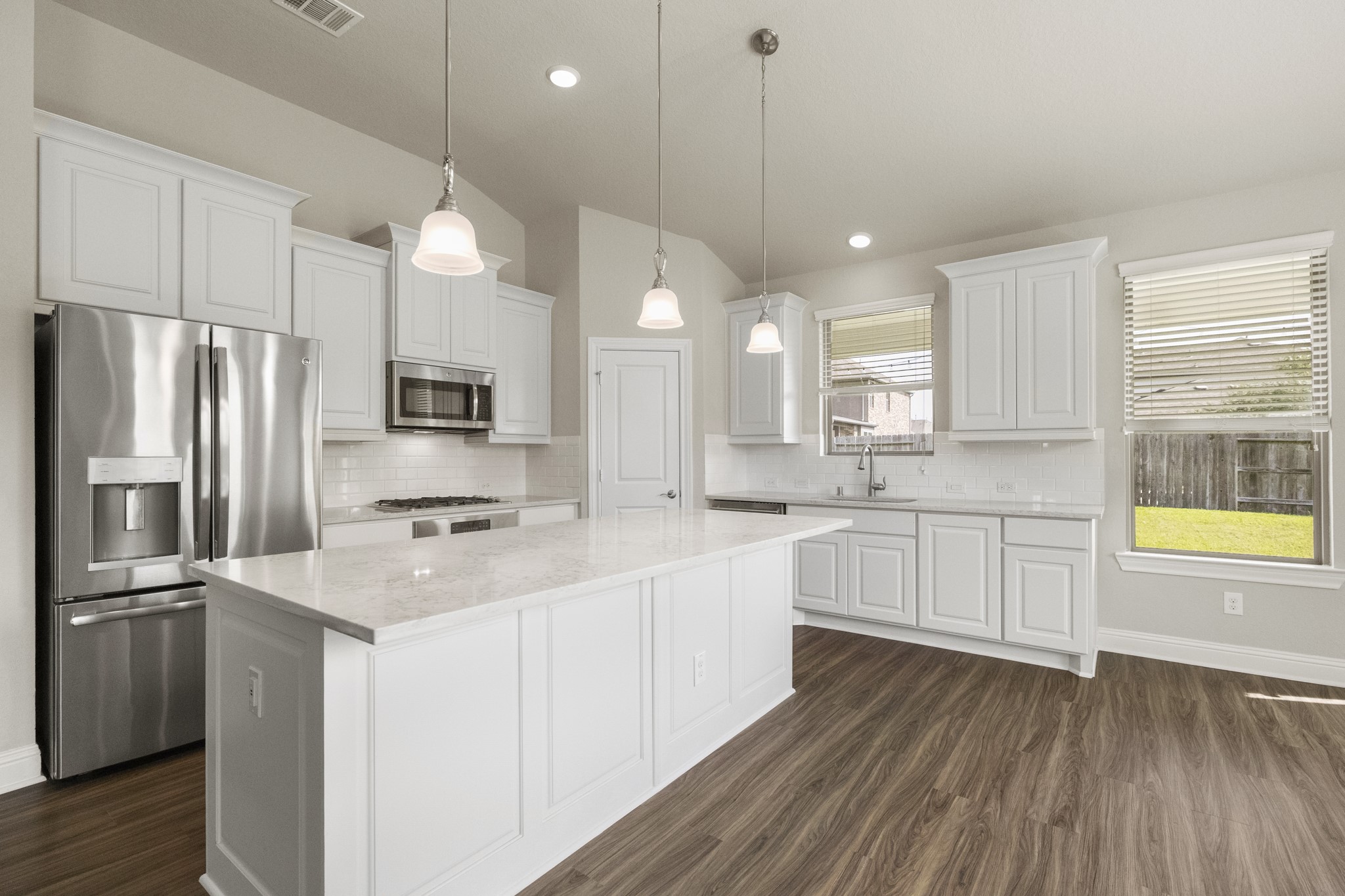 7502 Windsor Park Court Spring, TX 77379 - Photo 12 of 50 a kitchen with white cabinets and stainless steel appliances
