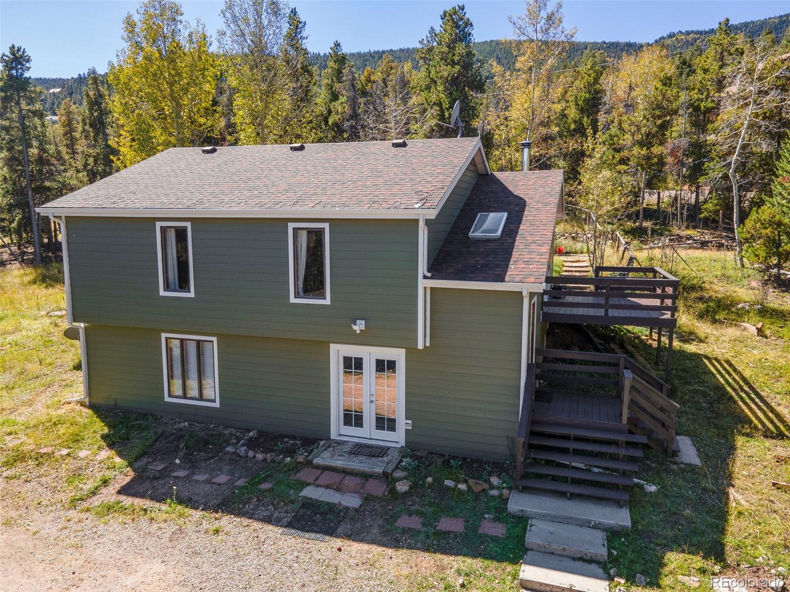 32252 Steven Way Conifer, CO 80433 - Photo 13 of 47 a view of a brick house with a large windows