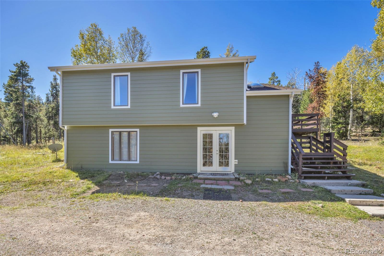 32252 Steven Way Conifer, CO 80433 - Photo 15 of 47 a front view of a house with a yard