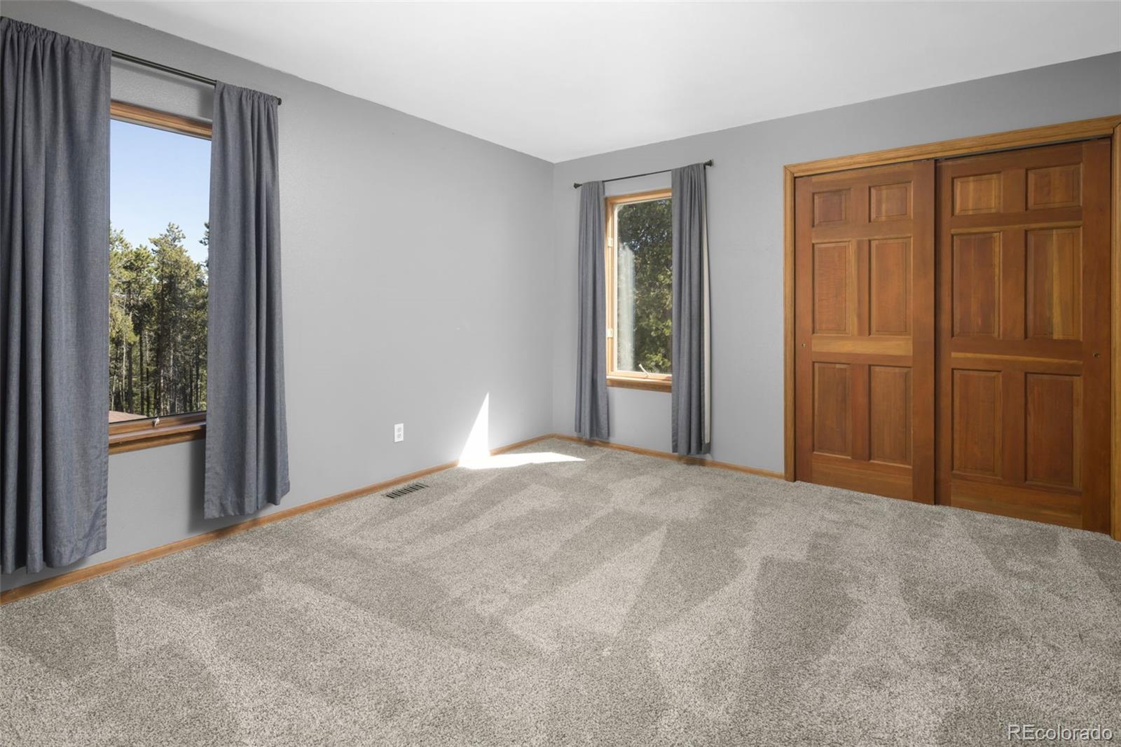 32252 Steven Way Conifer, CO 80433 - Photo 16 of 47 a view of an empty room with window and closet area