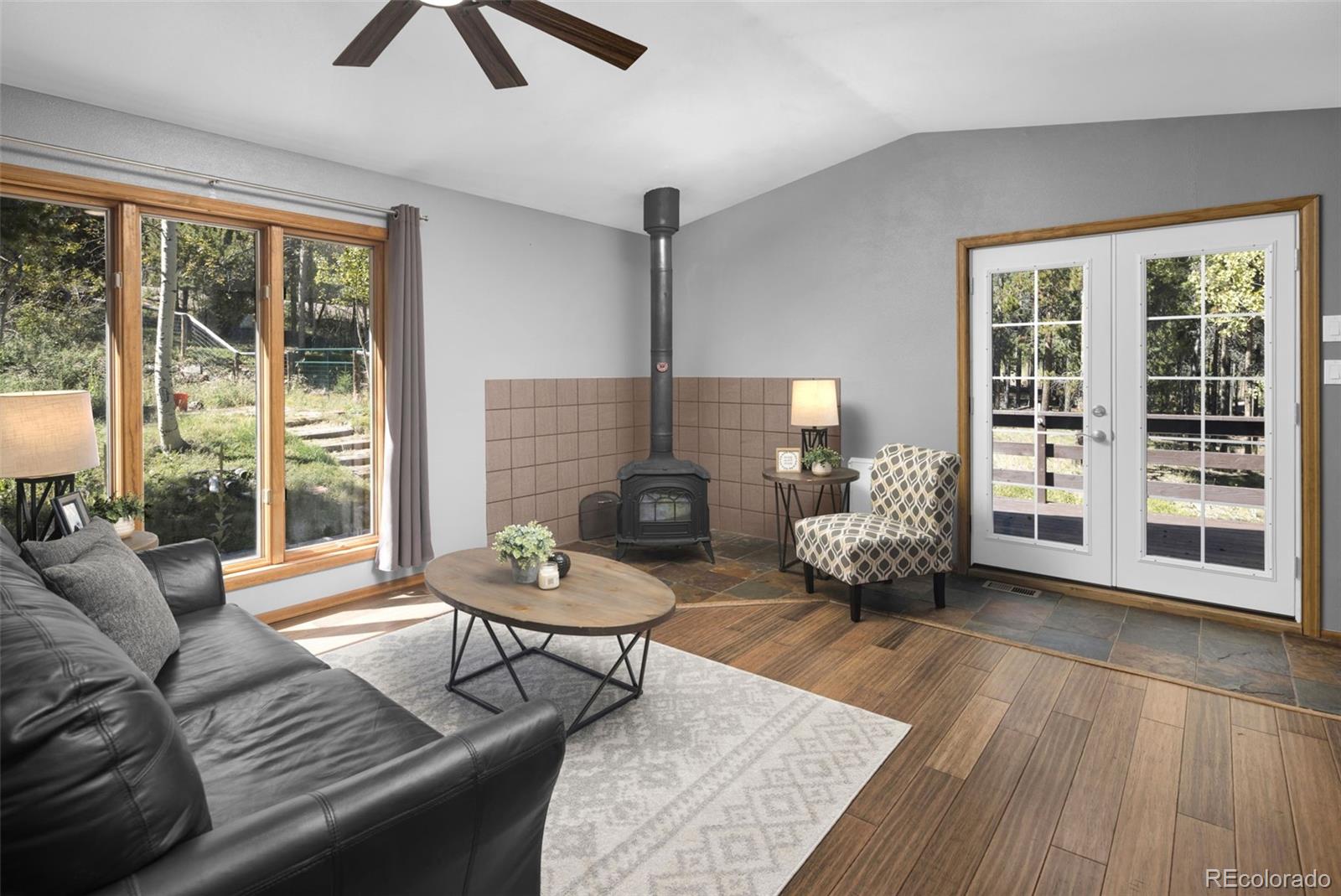 32252 Steven Way Conifer, CO 80433 - Photo 2 of 47 a living room with furniture and a floor to ceiling window