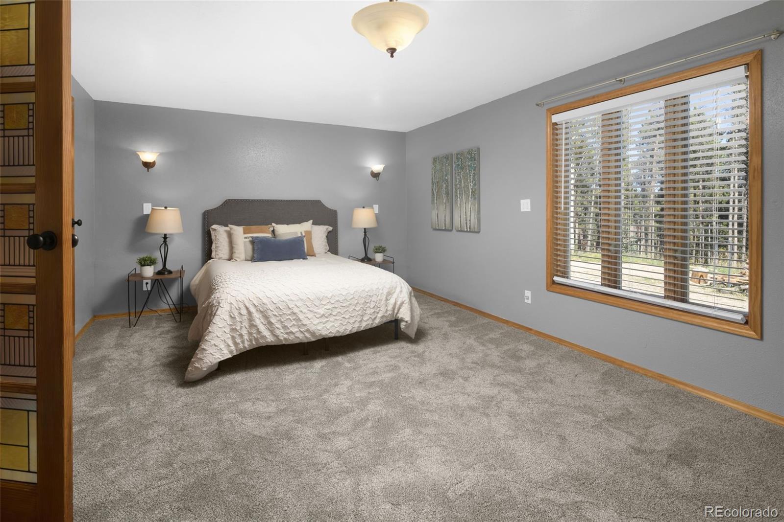 32252 Steven Way Conifer, CO 80433 - Photo 23 of 47 a bedroom with a bed and a window