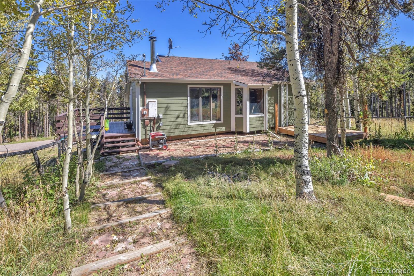 32252 Steven Way Conifer, CO 80433 - Photo 27 of 47 a front view of a house with garden