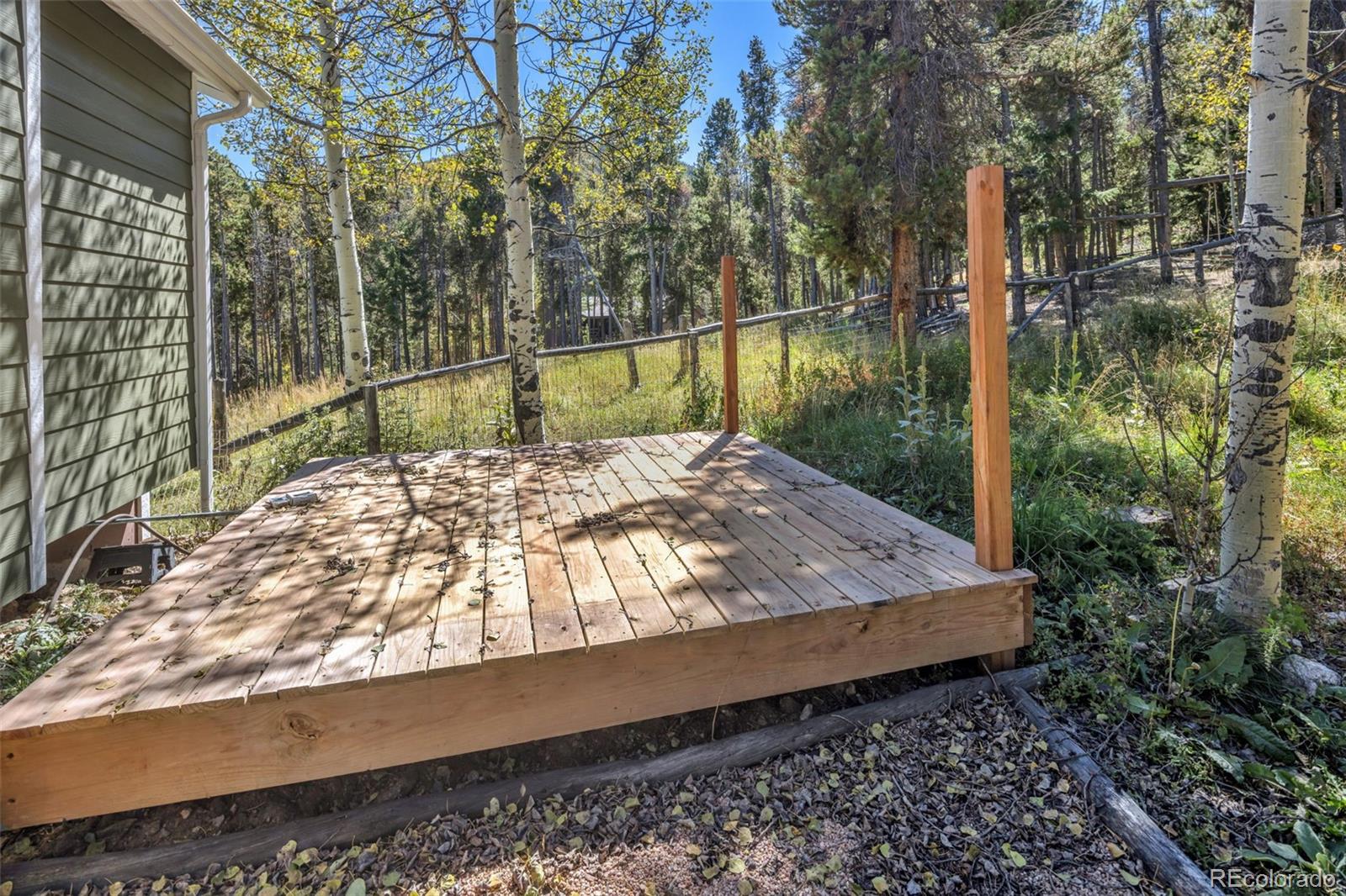 32252 Steven Way Conifer, CO 80433 - Photo 29 of 47 a view of a backyard with a lake view
