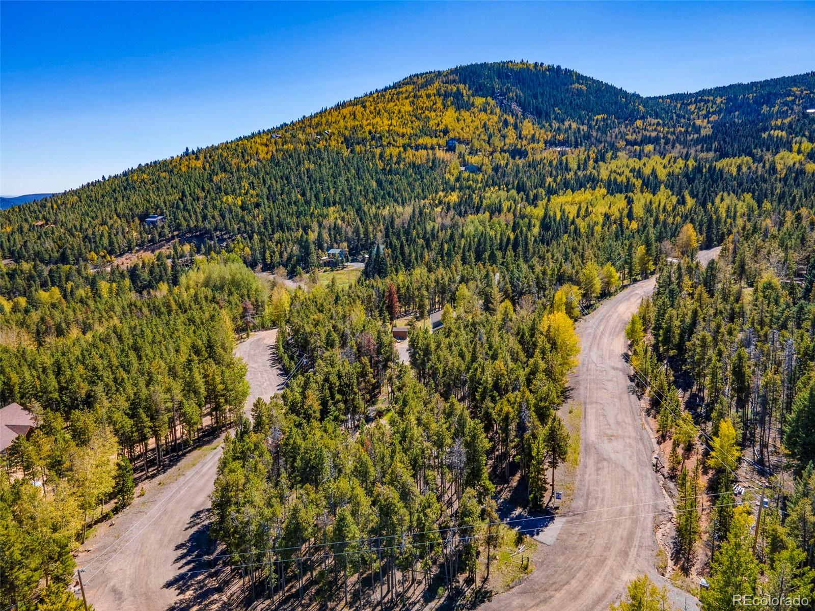 32252 Steven Way Conifer, CO 80433 - Photo 38 of 47 a view of a large building with a yard