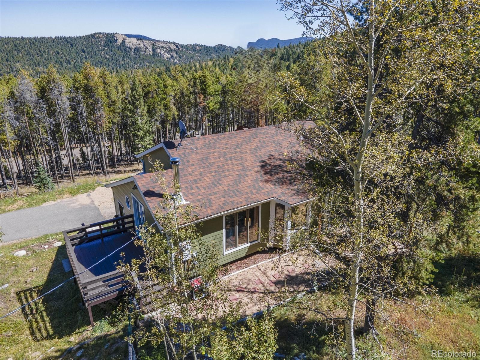 32252 Steven Way Conifer, CO 80433 - Photo 41 of 47 a view of a house with a yard from a patio