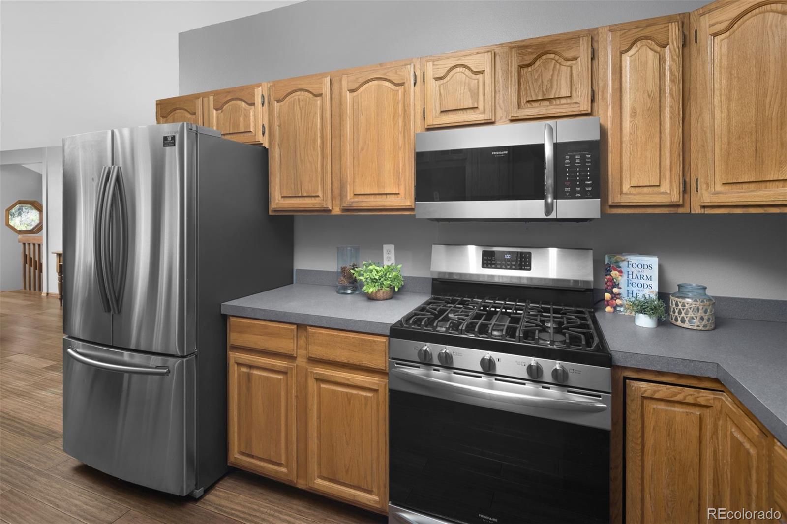 32252 Steven Way Conifer, CO 80433 - Photo 7 of 47 a kitchen with stainless steel appliances granite countertop a refrigerator stove and microwave