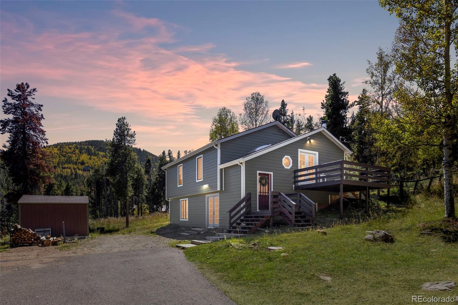 32252 Steven Way Conifer, CO 80433 - Photo 9 of 47 a view of a house with a yard and a garden
