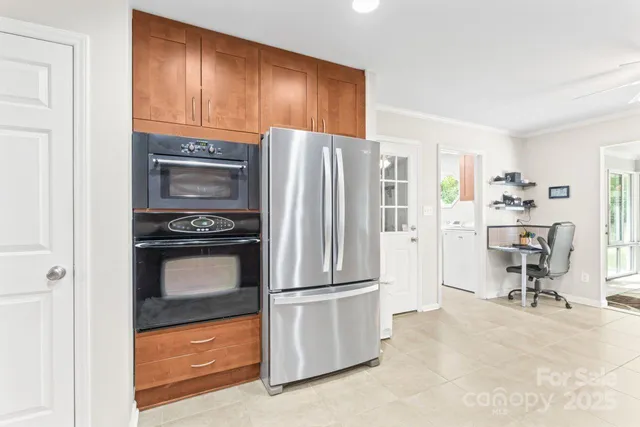 a kitchen with a refrigerator stove and wooden cabinets