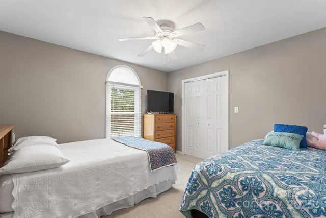 a bedroom with a large bed and a chandelier