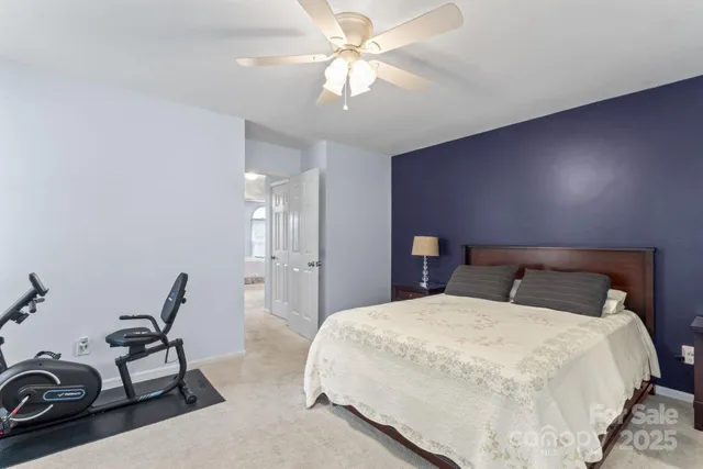 a bedroom with bed and a chandelier