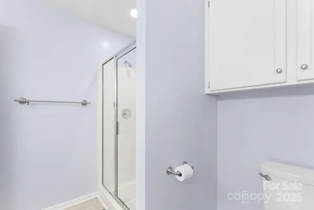 a bathroom with a shower and a sink