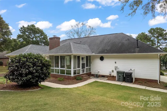 a view of a house with backyard and sitting area
