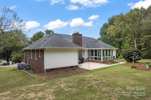 a view of a house with a yard and sitting area