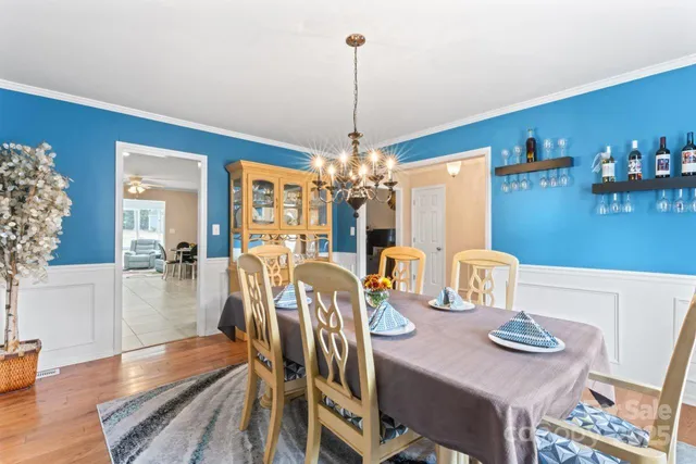 a view of a dining room with furniture wooden floor and chandelier