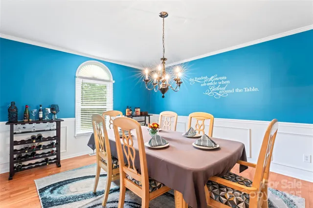 a view of a dining room with furniture and chandelier