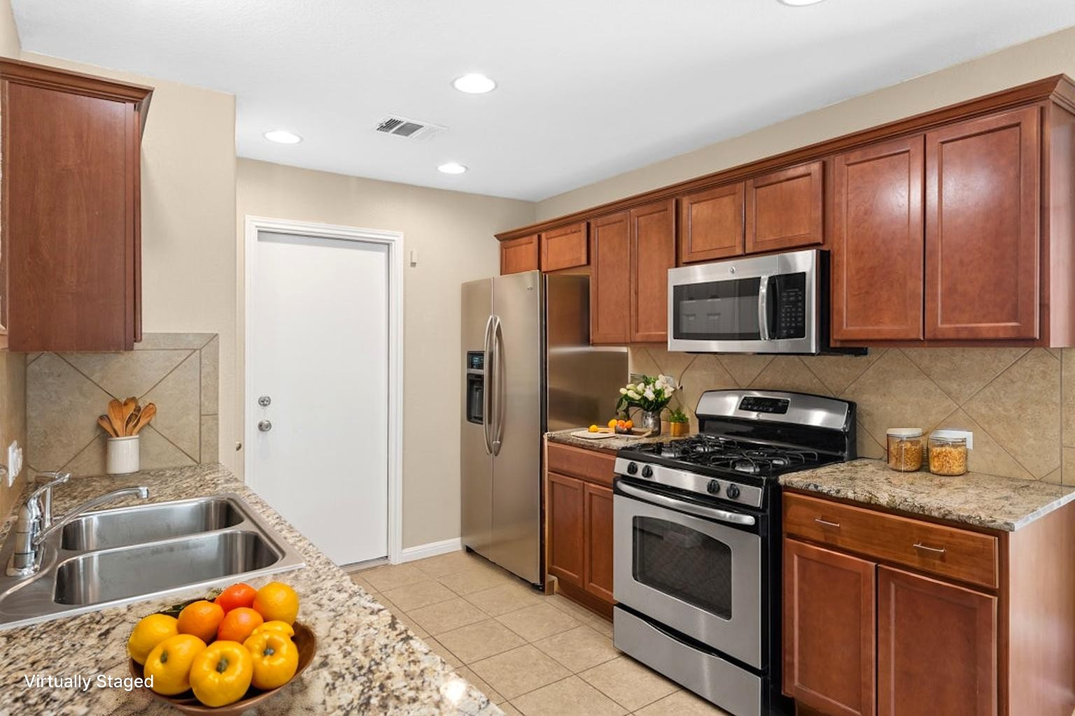 458 Nottingham Loop Kyle, TX 78640 - Photo 6 of 38 a kitchen with stainless steel appliances granite countertop a stove a sink and a microwave