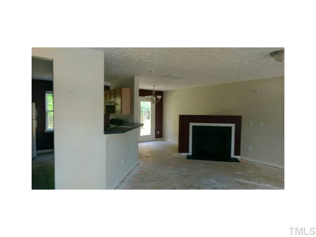 5808 Wynmore Road Raleigh, NC 27610 - Photo 3 of 5 a living room with a fireplace