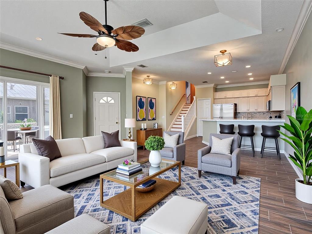 1801 Highland Road Osprey, FL 34229 - Photo 8 of 40 a living room with furniture kitchen view and a chandelier