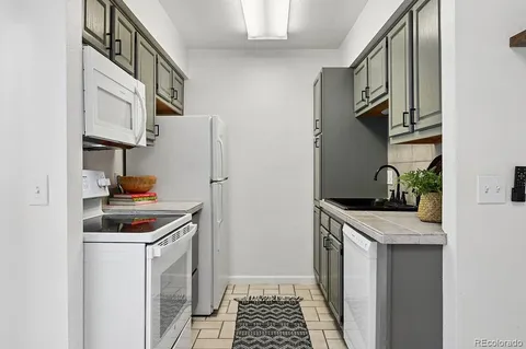 a kitchen with stainless steel appliances granite countertop a refrigerator and a stove