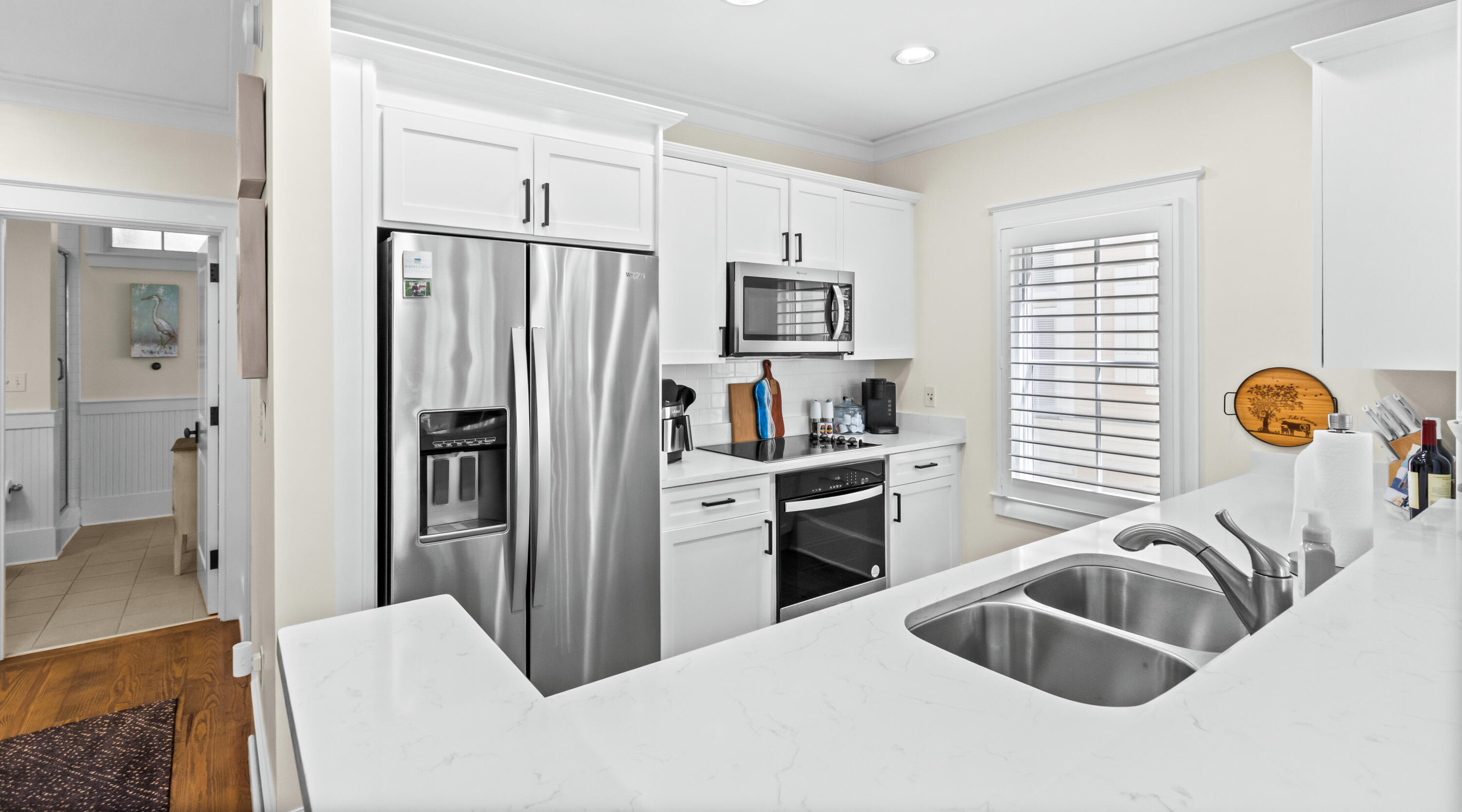 1660 East County Highway 30A, Unit 101 Santa Rosa Beach, FL 32459 - Photo 36 of 67 a kitchen with stainless steel appliances granite countertop a refrigerator and a sink