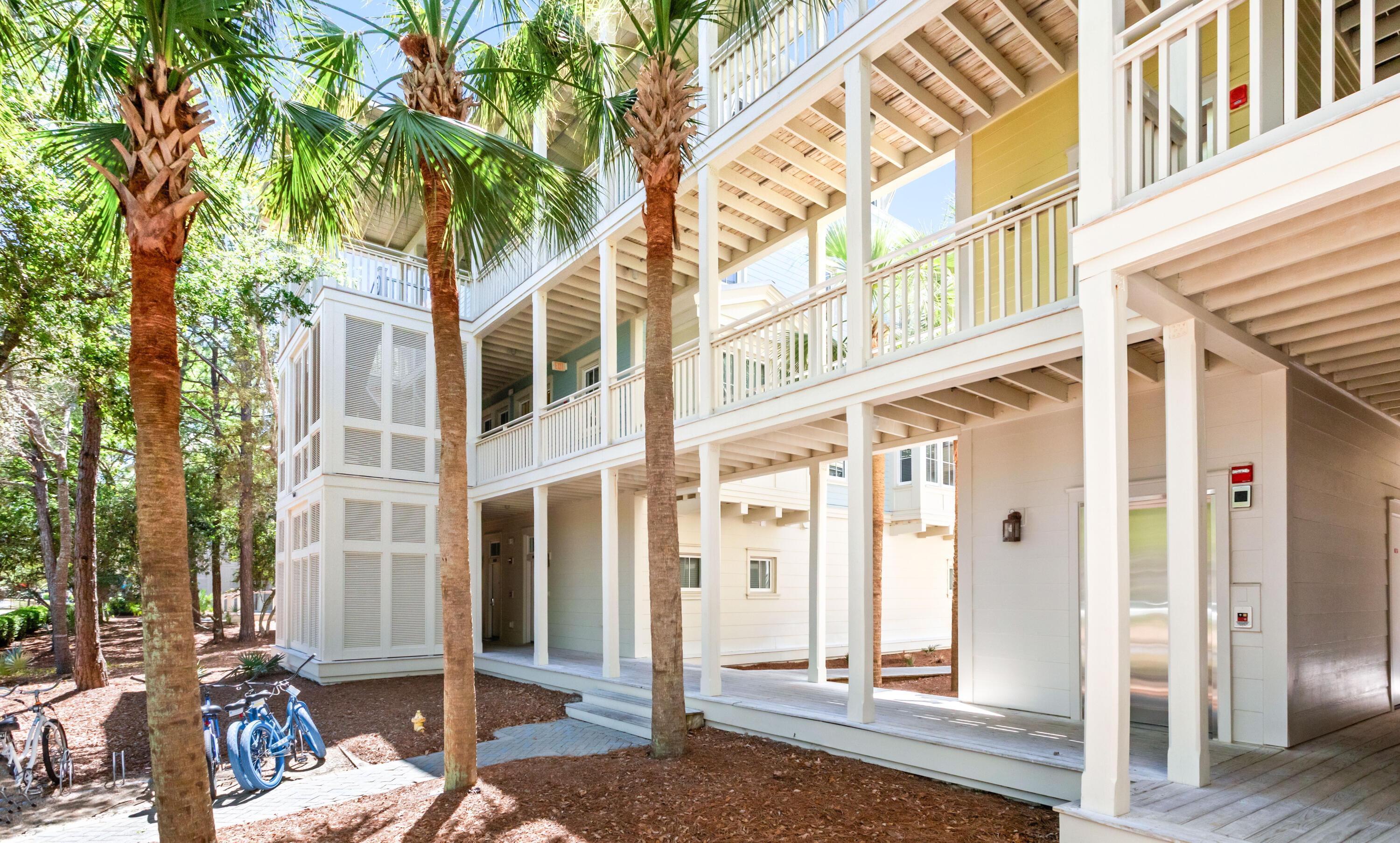 1660 East County Highway 30A, Unit 101 Santa Rosa Beach, FL 32459 - Photo 49 of 67 a front view of a building with a tree